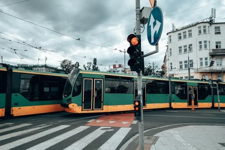 Green and yellow tram in city street exterior