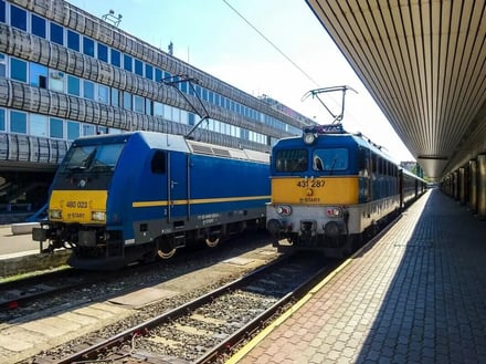Two trains at a station exterior
