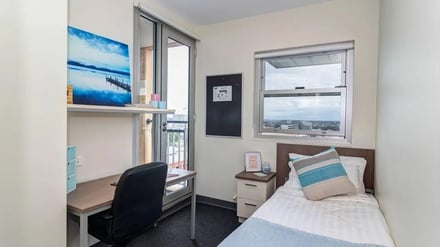 Desk bed window and artwork bedroom at UniLodge @ Metro Adelaide in Adelaide Student Accommodation