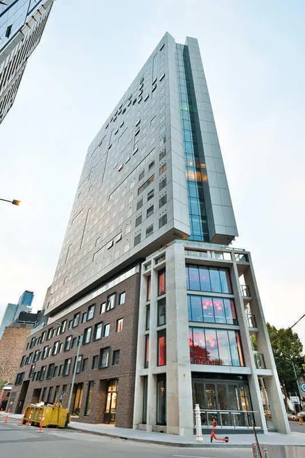 Modern high rise building with large windows exterior at Scape Victoria Street in Melbourne Student Accommodation