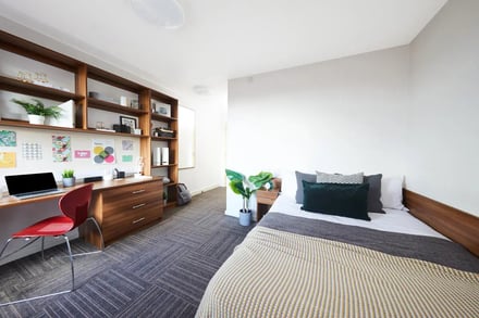Desk shelves laptop chair and bed bedroom at Collegiate Bagot Street in Birmingham Student Accommodation