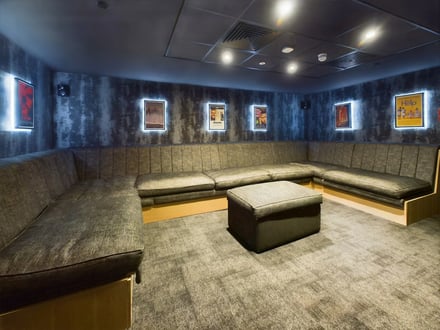 L-shaped sofa ottoman movie posters common area at Crown Place - Nottingham in Nottingham Student Accommodation