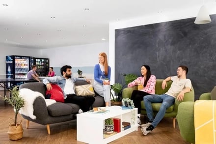 Students relaxing on sofas near vending machines living area at Kelvin Court in Glasgow Student Accommodation
