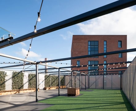 Pergola lights artificial turf wooden planter exterior at Aspen Dublin in Dublin Student Accommodation