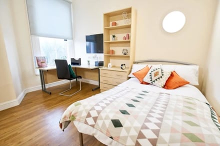 Bed desk shelf and pillows bedroom at Daisybank Villas in Manchester Student Accommodation