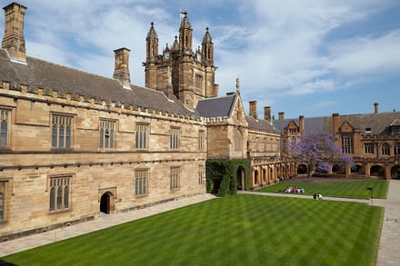 Courtyard with lawns and gothic buildings exterior at University Of Sydney Accommodation