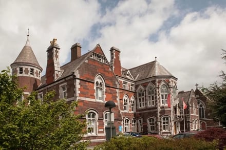 Red brick building turret and cars exterior at Griffith College Dublin Accommodation