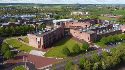 Brick campus buildings with green lawns and trees exterior at Munster Technological University Accommodation