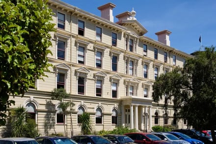 Grand building with many windows cars parked exterior at Victoria University Of Wellington Accommodation