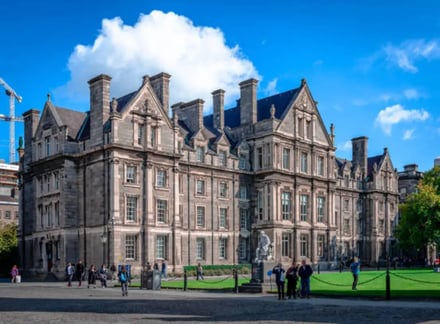 Historic stone building with students outside exterior at University College Dublin Accommodation
