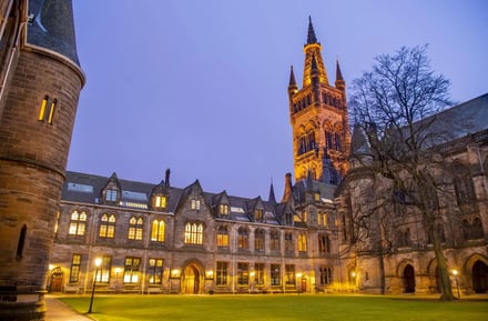 Historic building with illuminated windows and tower exterior at University Of Glasgow Accommodation