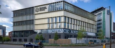 Modern building with university logo exterior at Manchester Metropolitan University Accommodation