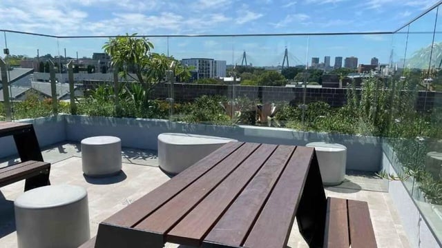 Outdoor seating area with picnic table and stools exterior at UniLodge Ultimo in Sydney Student Accommodation