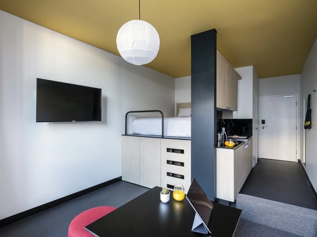Lofted bed, kitchen, desk, TV studio apartment at UKO Newtown in Sydney Student Accommodation