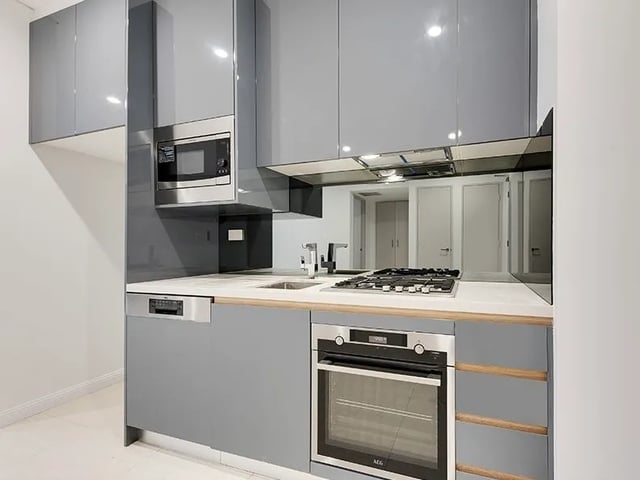 Gray cabinets microwave oven stove dishwasher kitchen at Belong Mascot in Sydney Student Accommodation