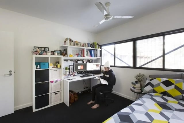 Desk bed and storage shelves bedroom at UNSW Village in Sydney Student Accommodation