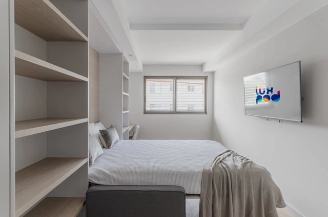 Bed with shelves and TV bedroom at UKO Kensington in Sydney Student Accommodation