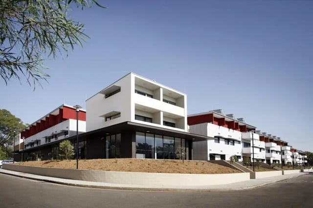 Modern white and red buildings with balconies exterior at Western Sydney University Village Parramatta Campus in Sydney Student Accommodation