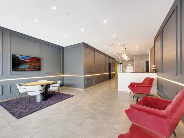 Modern reception area with lounge seating and table at Belong Rosebery in Sydney Student Accommodation