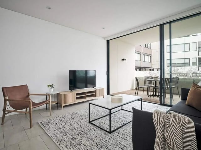 Leather armchair tv stand and rug living room at UKO Camperdown in Sydney Student Accommodation