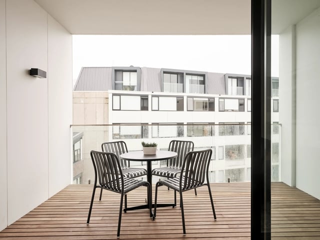 Balcony with table chairs and plant exterior at UKO Camperdown in Sydney Student Accommodation
