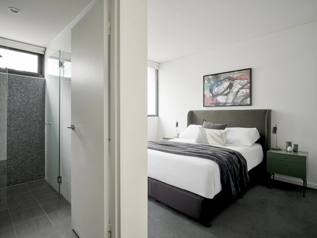 Bedroom with bed shower and abstract art Bedroom at UKO Camperdown in Sydney Student Accommodation