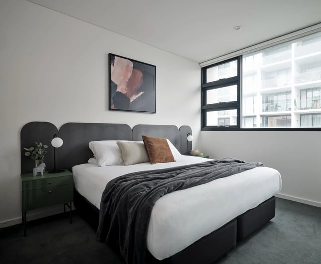 Bed with artwork side table and window bedroom at UKO Camperdown in Sydney Student Accommodation
