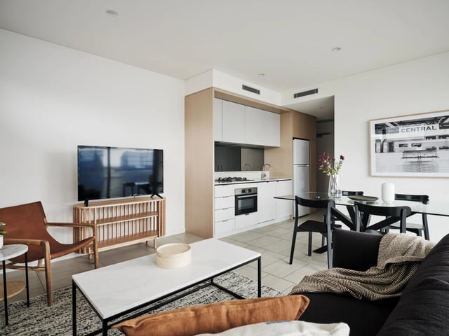 Modern living room with kitchen and dining area at UKO Camperdown in Sydney Student Accommodation
