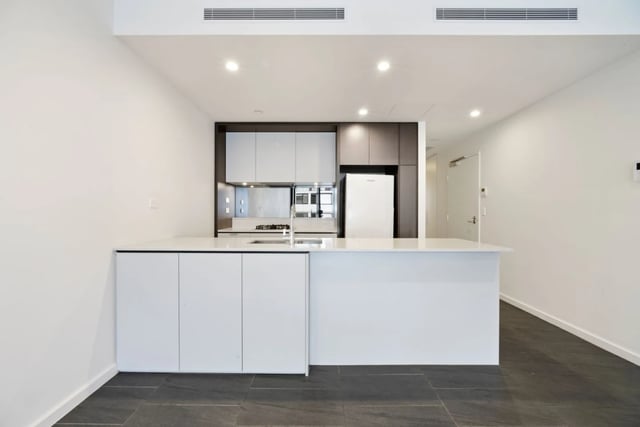 Modern kitchen with white cabinets fridge and sink kitchen at UKO Camperdown in Sydney Student Accommodation