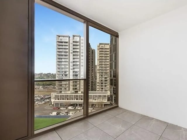 Empty room with city view balcony at Belong Parramatta in Sydney Student Accommodation