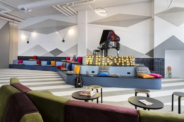 Piano welcome sign tiered seating living room at Campus Perth in Perth Student Accommodation