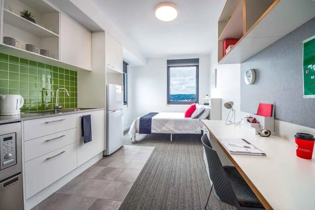 Kitchen bed desk and window Student studio at dwell East End Adelaide in Adelaide Student Accommodation