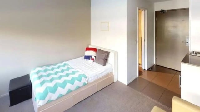 Single bed with patterned duvet and pillows bedroom at Student Living D1 in Melbourne Student Accommodation