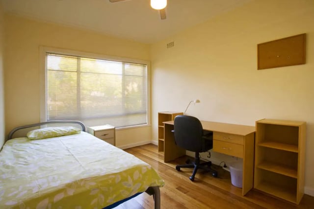 Bed desk chair and shelves bedroom study area at Classical House in Melbourne Student Accommodation