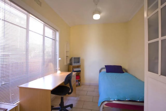 Desk chair TV and bed student room bedroom at Classical House in Melbourne Student Accommodation