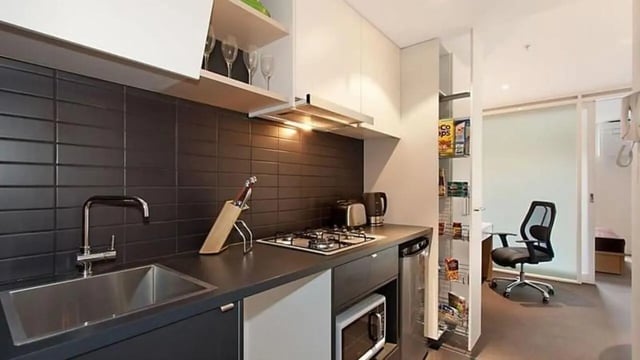 Modern kitchen with sink stove and storage kitchen at Student Living on Villiers in Melbourne Student Accommodation
