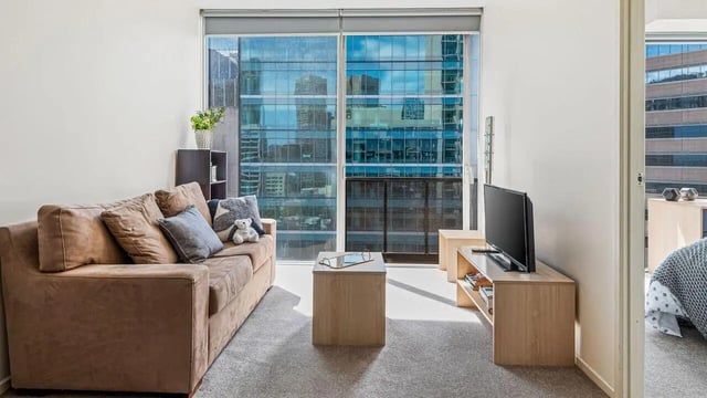 Brown sofa television and coffee table living room at Student Living on Lonsdale in Melbourne Student Accommodation