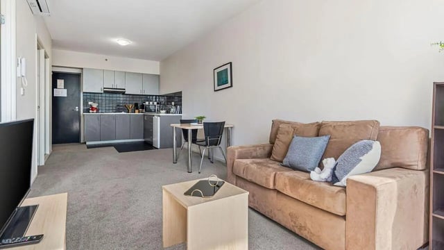 Sofa kitchen table and TV living area at Student Living on Lonsdale in Melbourne Student Accommodation