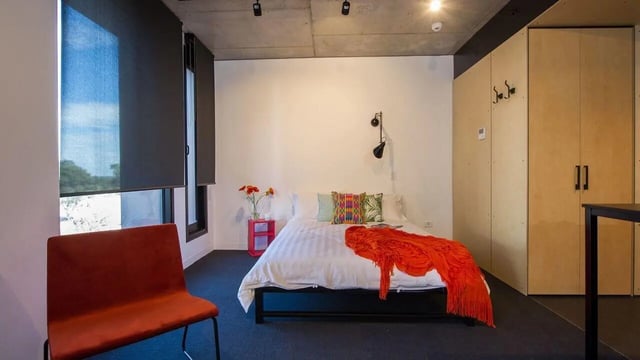 Bed with orange throw side table closet bedroom at UniLodge @ RMIT Bundoora-Walert House in Melbourne Student Accommodation