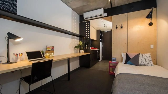Desk with laptop and bed living room at UniLodge @ RMIT Bundoora-Walert House in Melbourne Student Accommodation