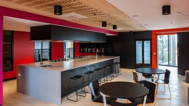 Large kitchen island with stools and tables kitchen at UniLodge @ RMIT Bundoora-Walert House in Melbourne Student Accommodation