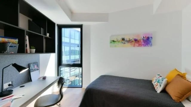Desk lamp bed with colorful pillows bedroom at UniLodge Toowong in Brisbane Student Accommodation