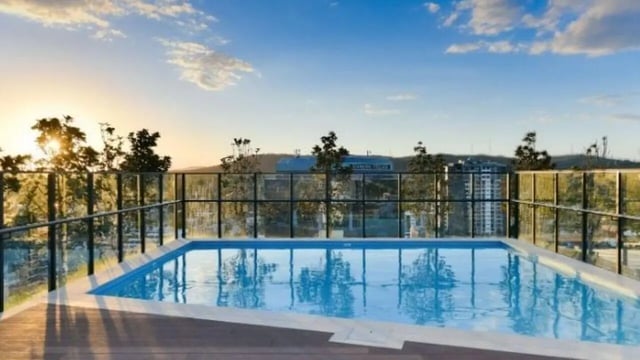 Swimming pool with deck and glass fence exterior at UniLodge Toowong in Brisbane Student Accommodation