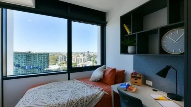 Bed pillows desk shelf clock study bedroom at UniLodge Toowong in Brisbane Student Accommodation