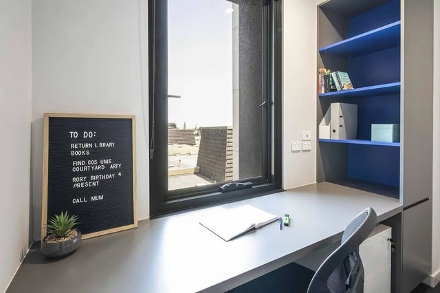 Desk with to do list and bookshelf study area at dwell Village Melbourne City in Melbourne Student Accommodation