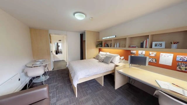 Bed desk shelves and table student bedroom at dwell Village Melbourne City in Melbourne Student Accommodation
