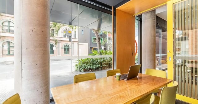 Table with laptop and chairs study area at Iglu Central in Sydney Student Accommodation