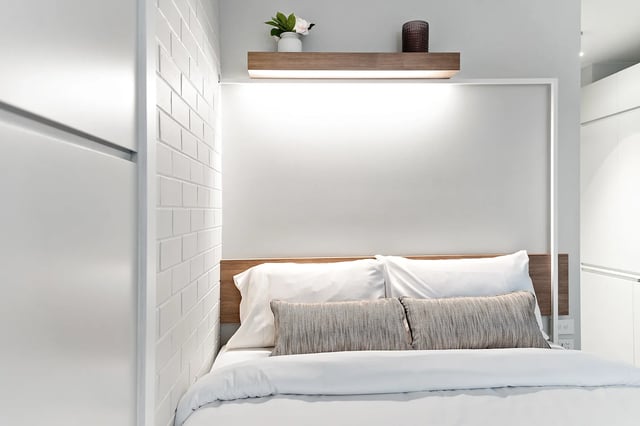 Bed with white linens and pillows bedroom at UKO Paddington in Sydney Student Accommodation