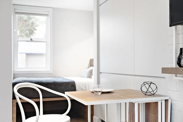 White chair bed window and table bedroom interior at UKO Paddington in Sydney Student Accommodation