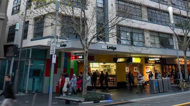UniLodge exterior with street level shops and pedestrians exterior at Student Living-339 Swanston in Melbourne Student Accommodation
